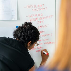 Female Engineer Writing on Whiteboard