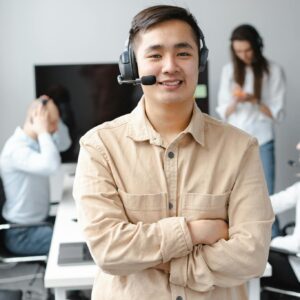 Smiling Man in Brown Long Sleeve Shirt Wearing Headphones